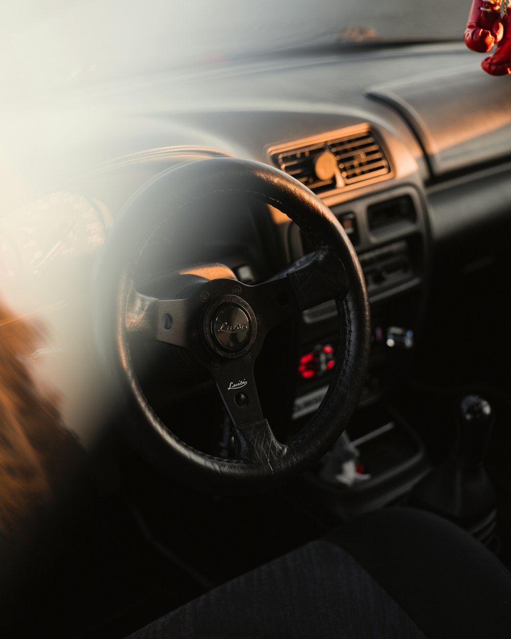 a person driving a car with a steering wheel