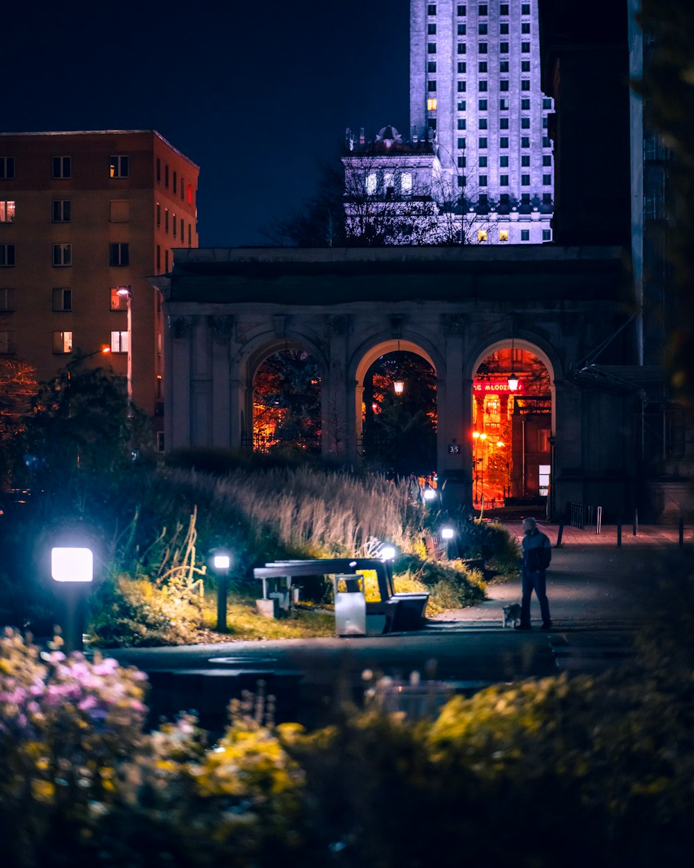 a man standing in front of a building at night