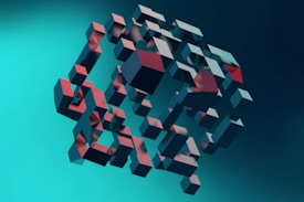 A collection of three-dimensional cubes is suspended in mid-air against a gradient teal background. The cubes vary in size and orientation, creating a dynamic and abstract pattern. The interplay of light and shadow on the cubes gives them a metallic appearance with hints of red and blue.