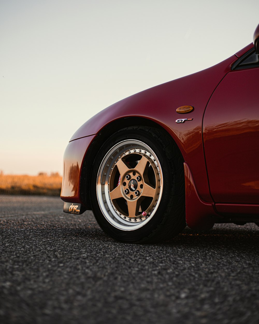 a red sports car parked in a parking lot