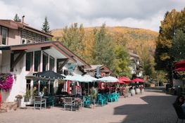 a row of tables with umbrellas on a street