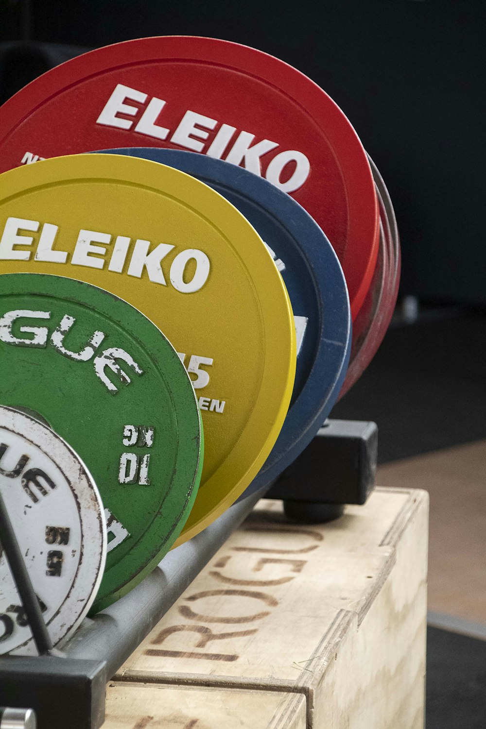 a row of colorful plates sitting on top of a wooden box