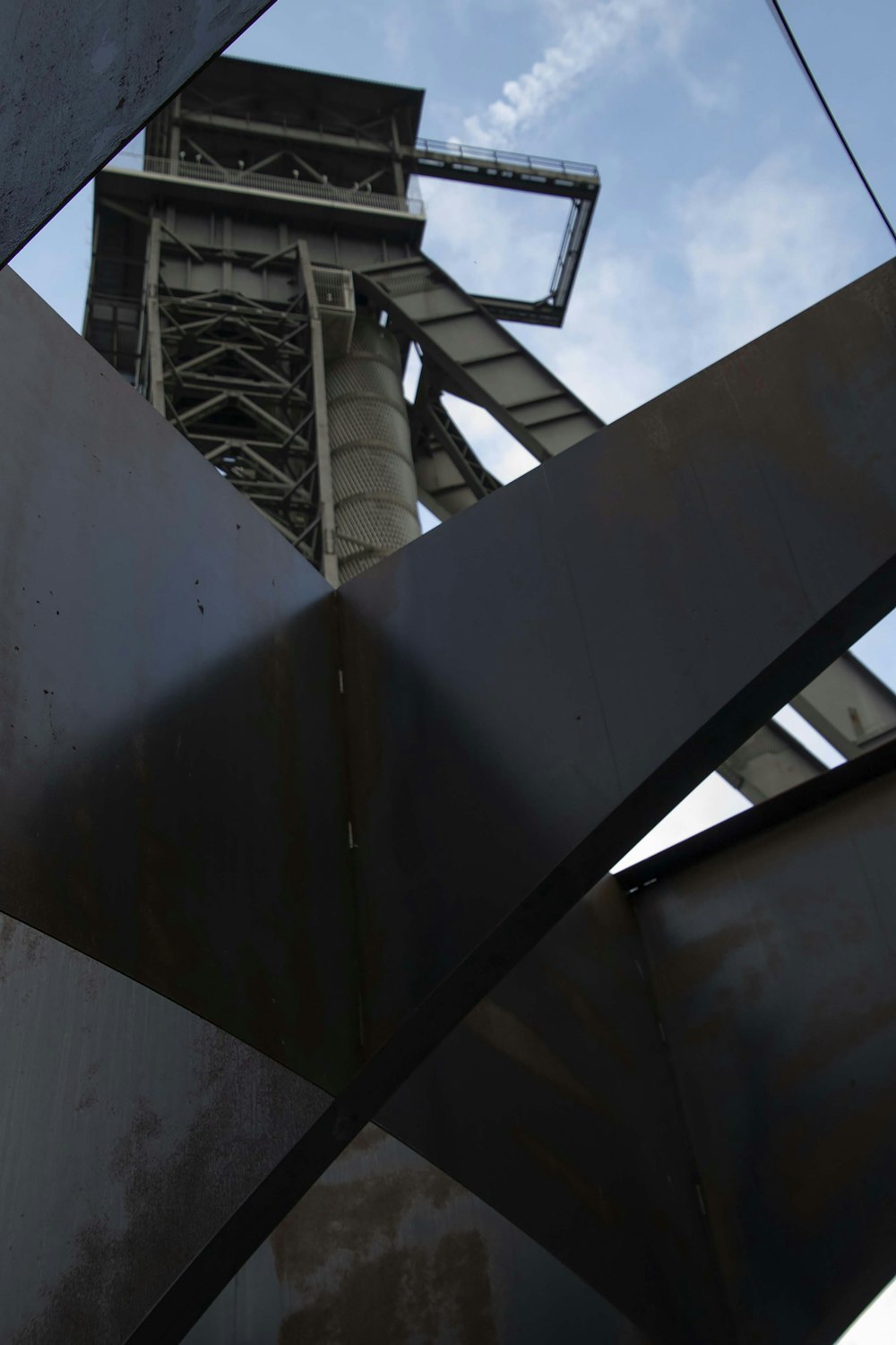 a large metal structure with a sky in the background