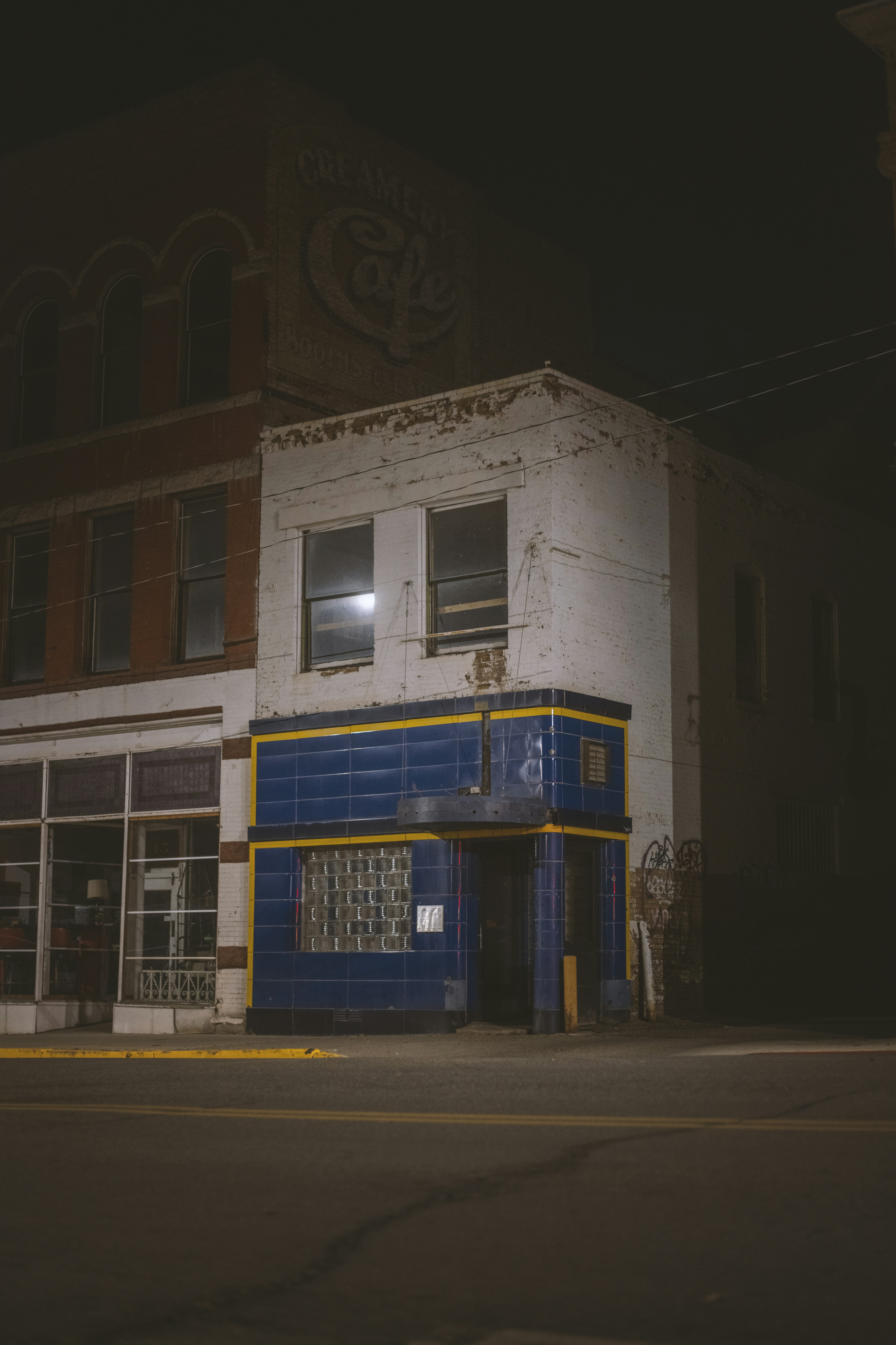 an old building with a blue and yellow front