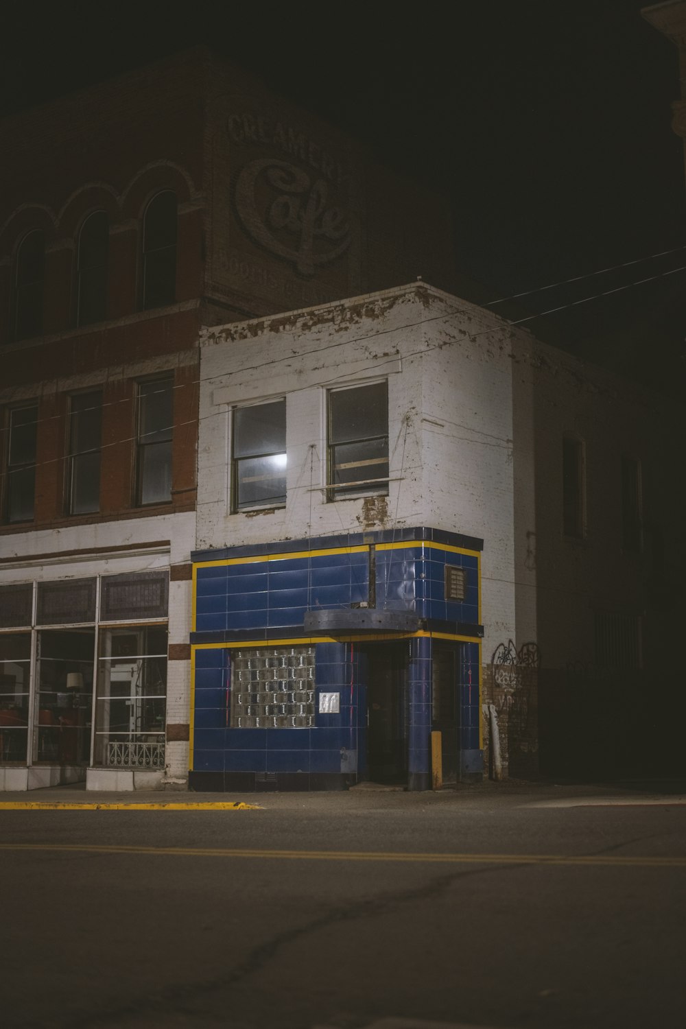 an old building with a blue and yellow front