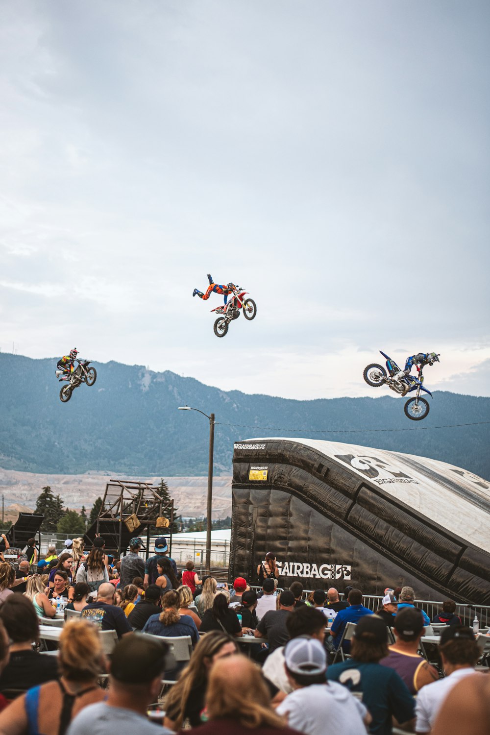 a group of people watching two people on motorcycles