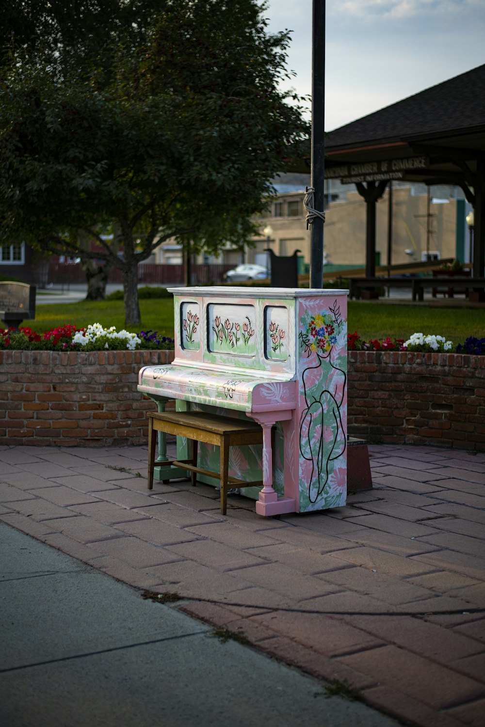 a pink piano sitting on top of a sidewalk