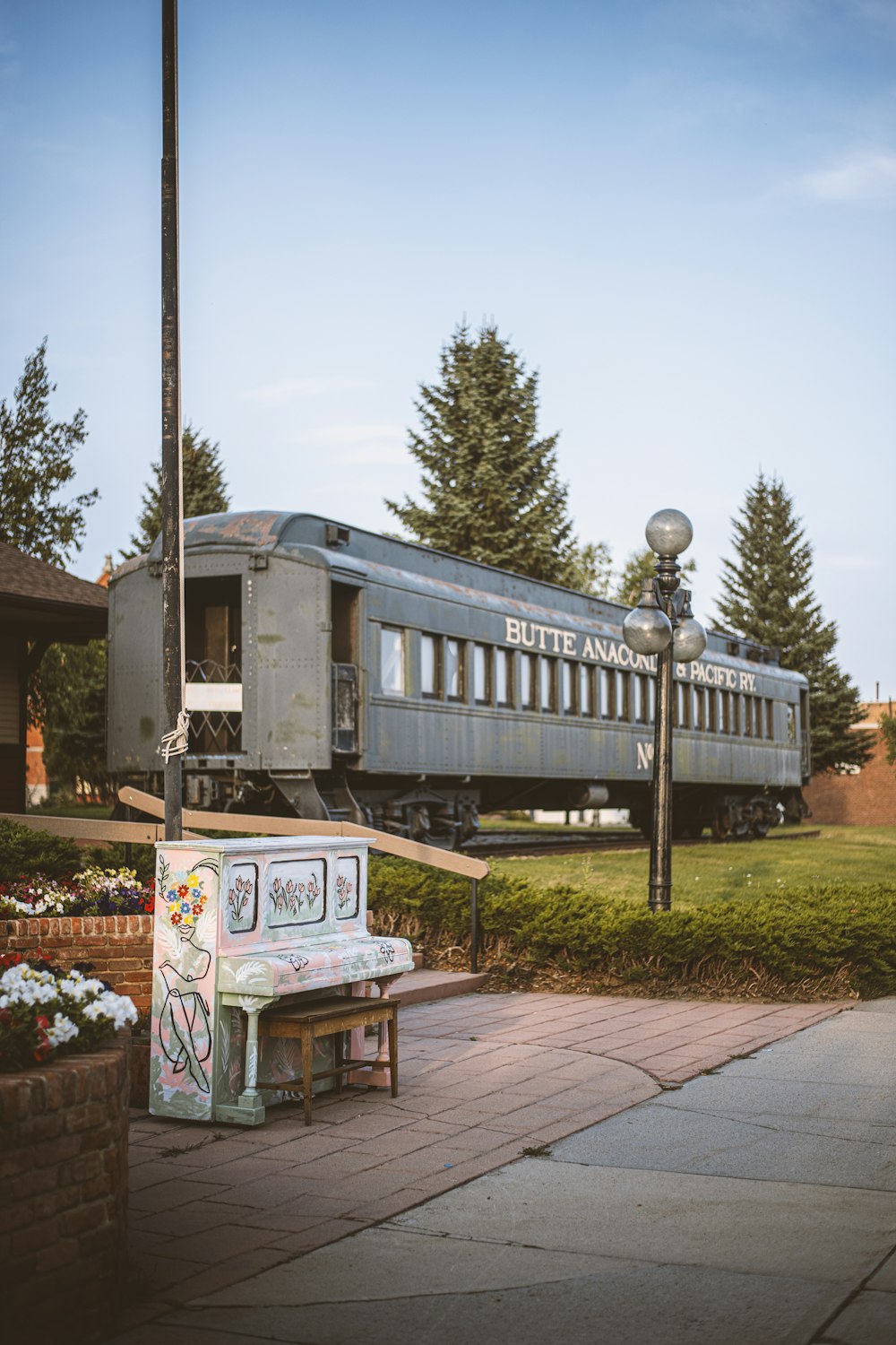 a train on a train track near a park