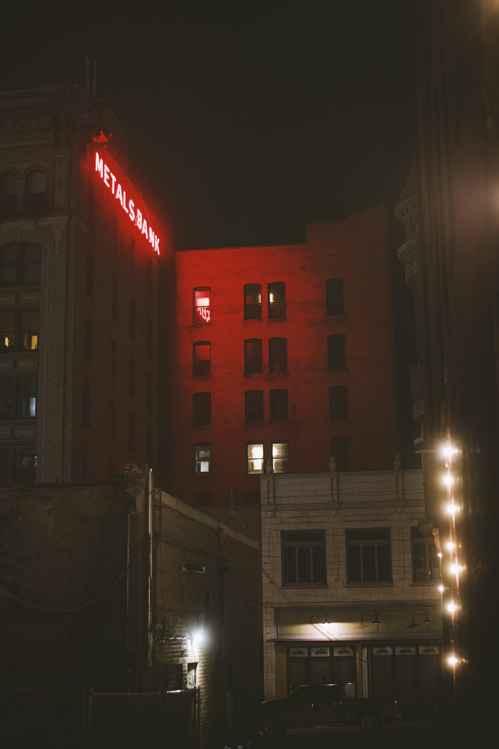 a red neon sign on the side of a building