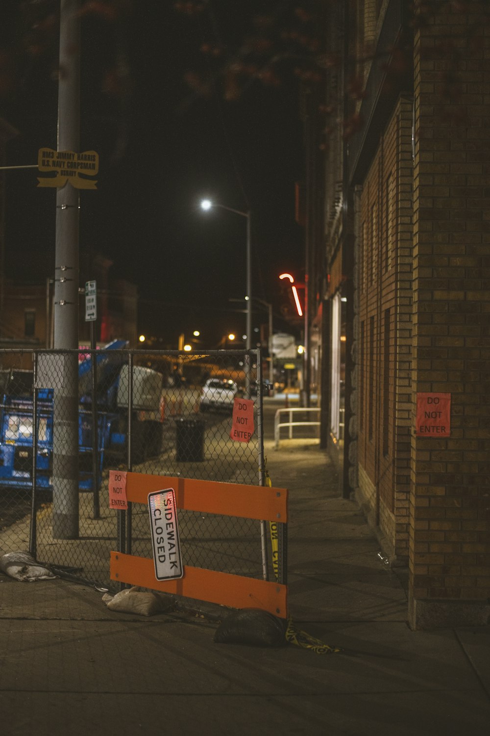 an orange barricade sitting on the side of a road