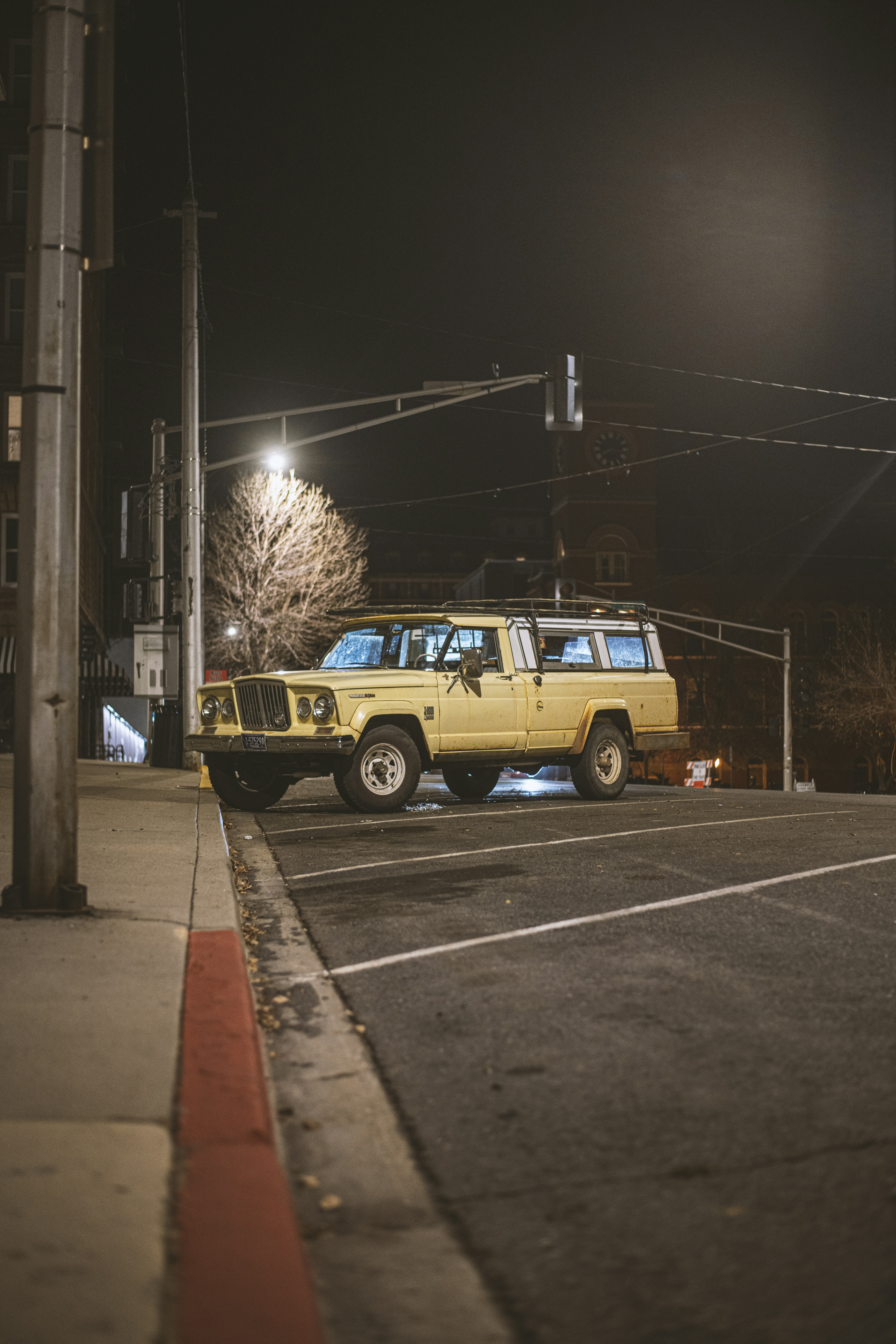 A yellow jeep parked on the side of the road photo – Free Car Image on ...