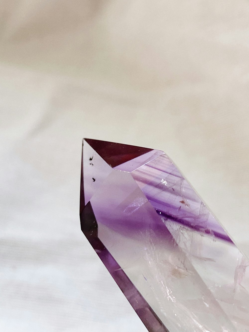 an amethyst shaped piece of glass sitting on a table