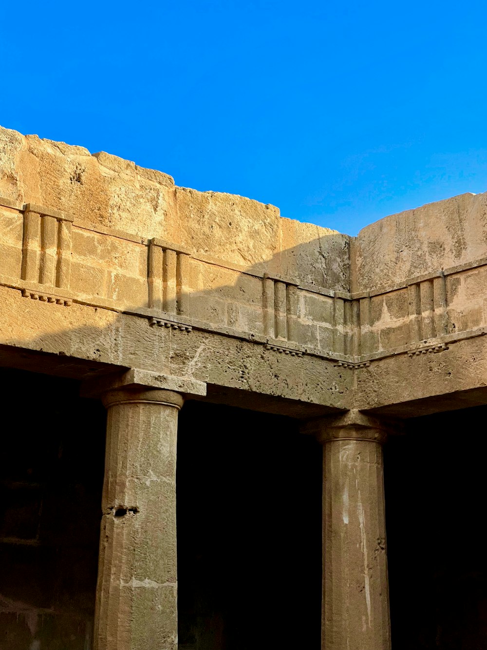 a clock on the side of a stone building