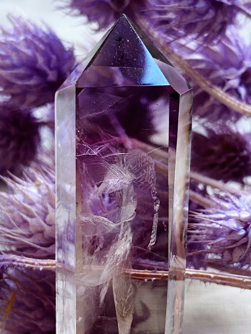a purple crystal with a figure inside of it