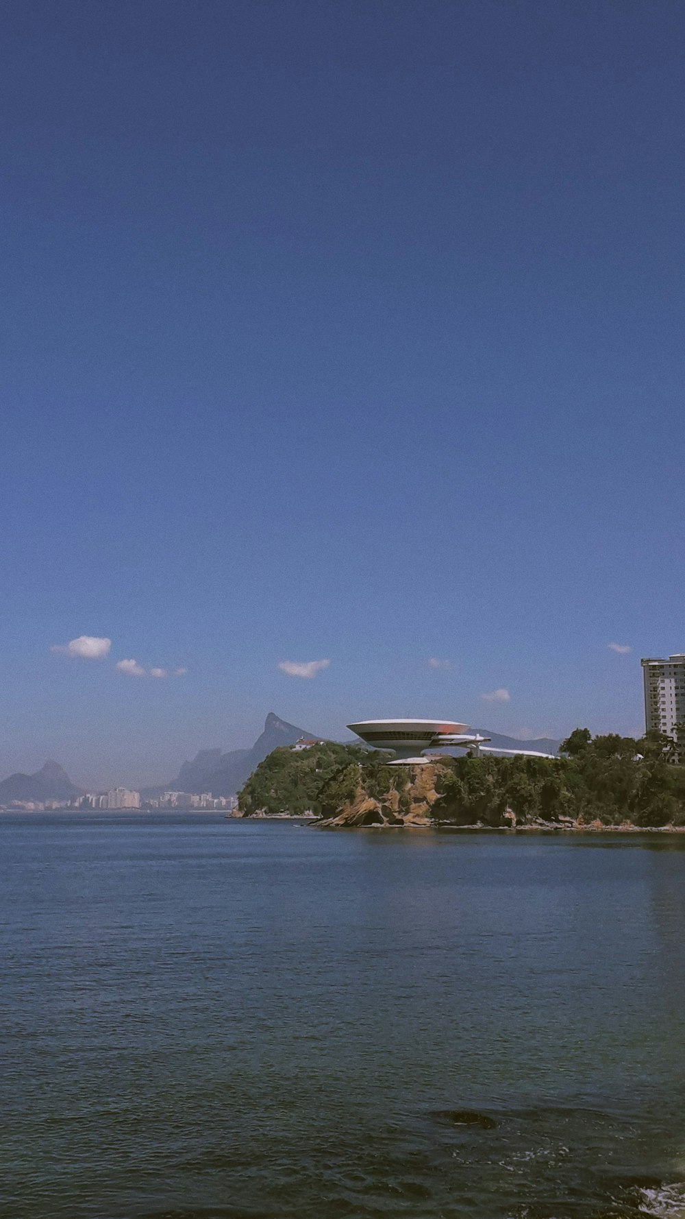 a large body of water with buildings in the background