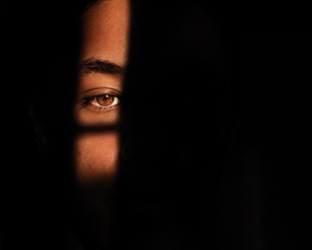 a close up of a person's face in the dark