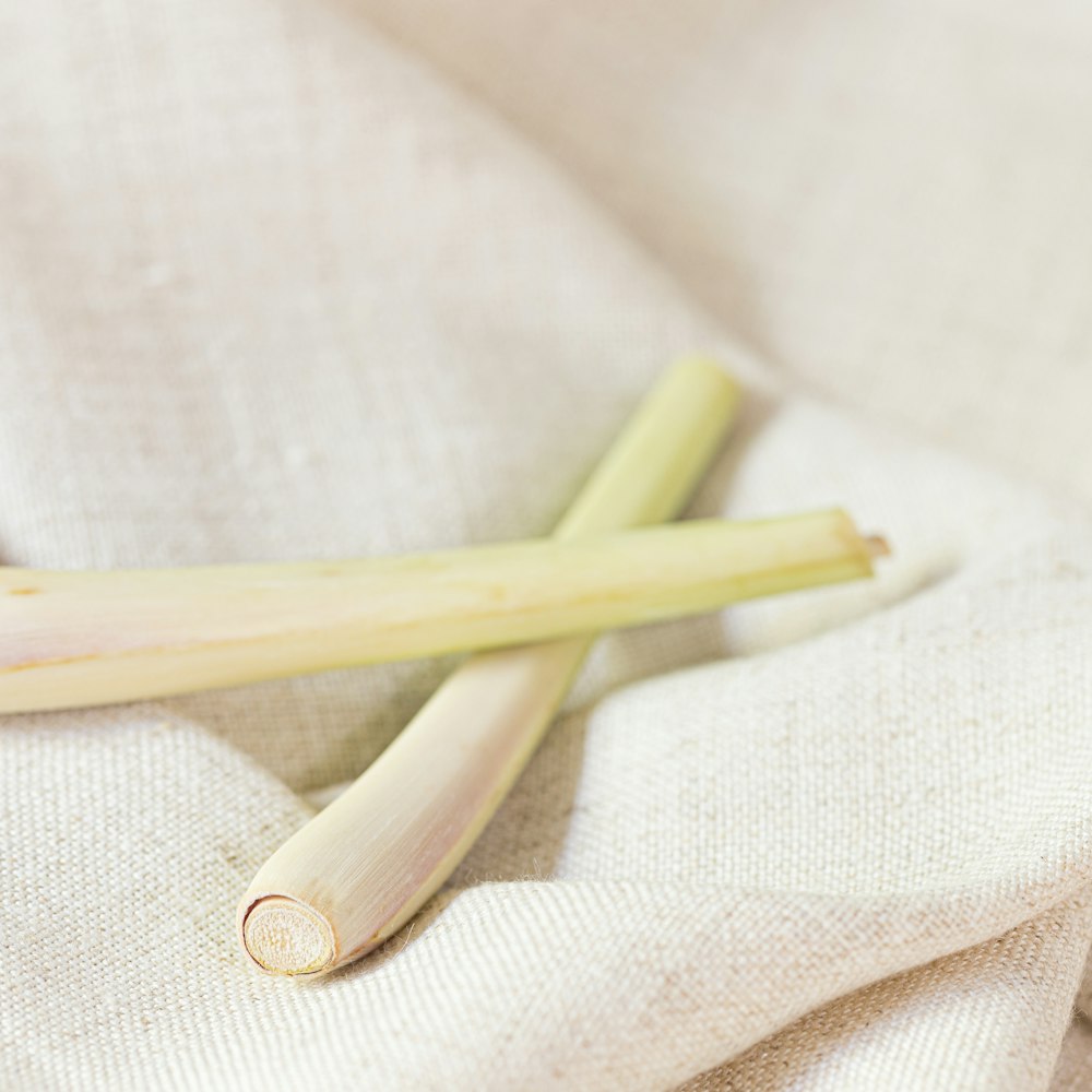 a couple of stalks of celery sitting on top of a white cloth