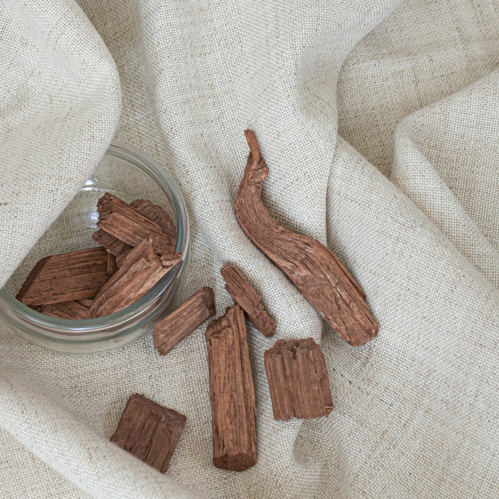 a glass bowl filled with pieces of wood