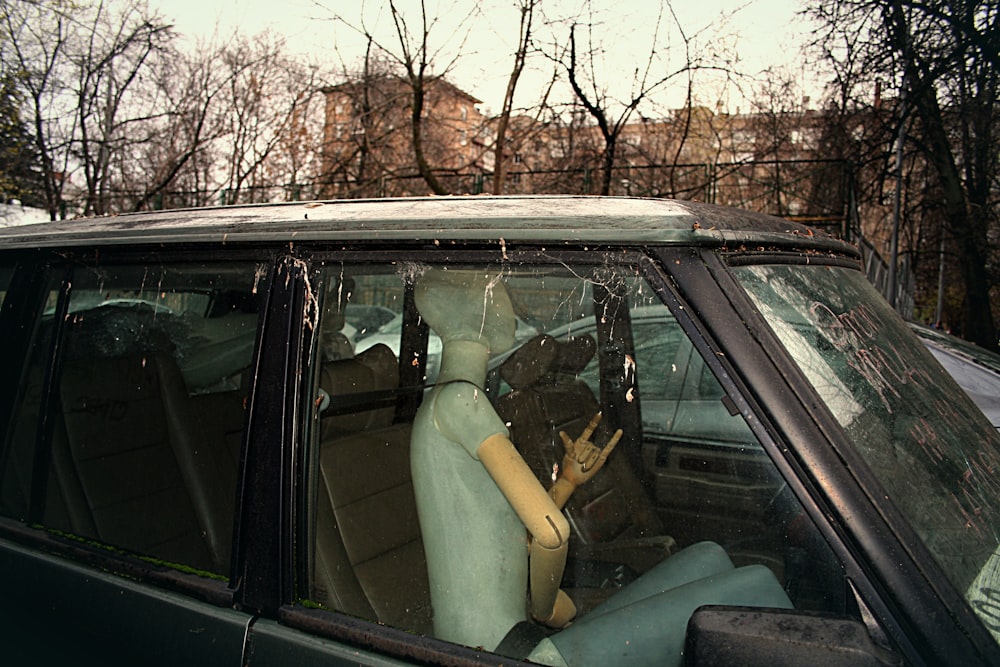 a car with a stuffed animal in the passenger seat