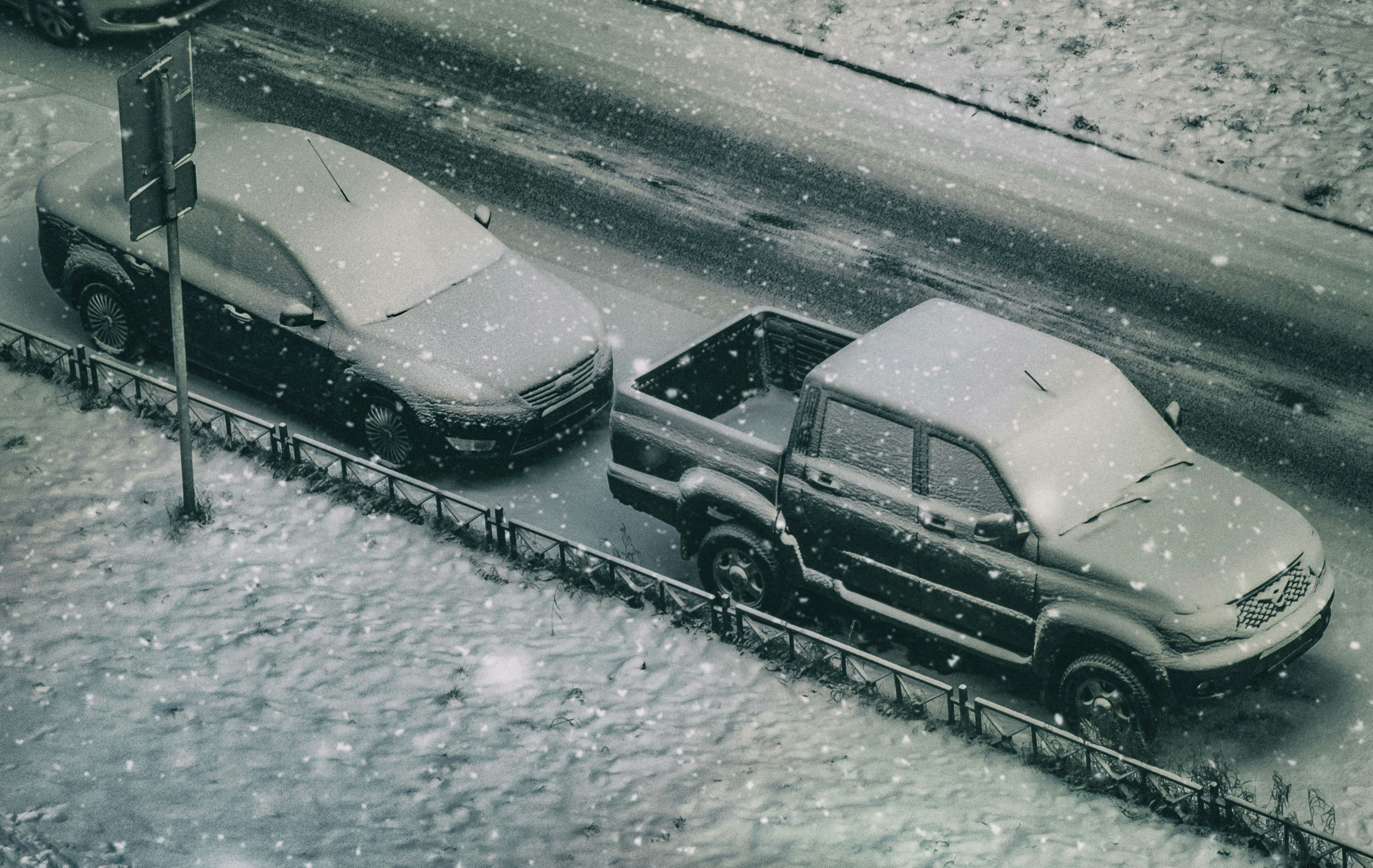 a couple of cars that are parked in the snow