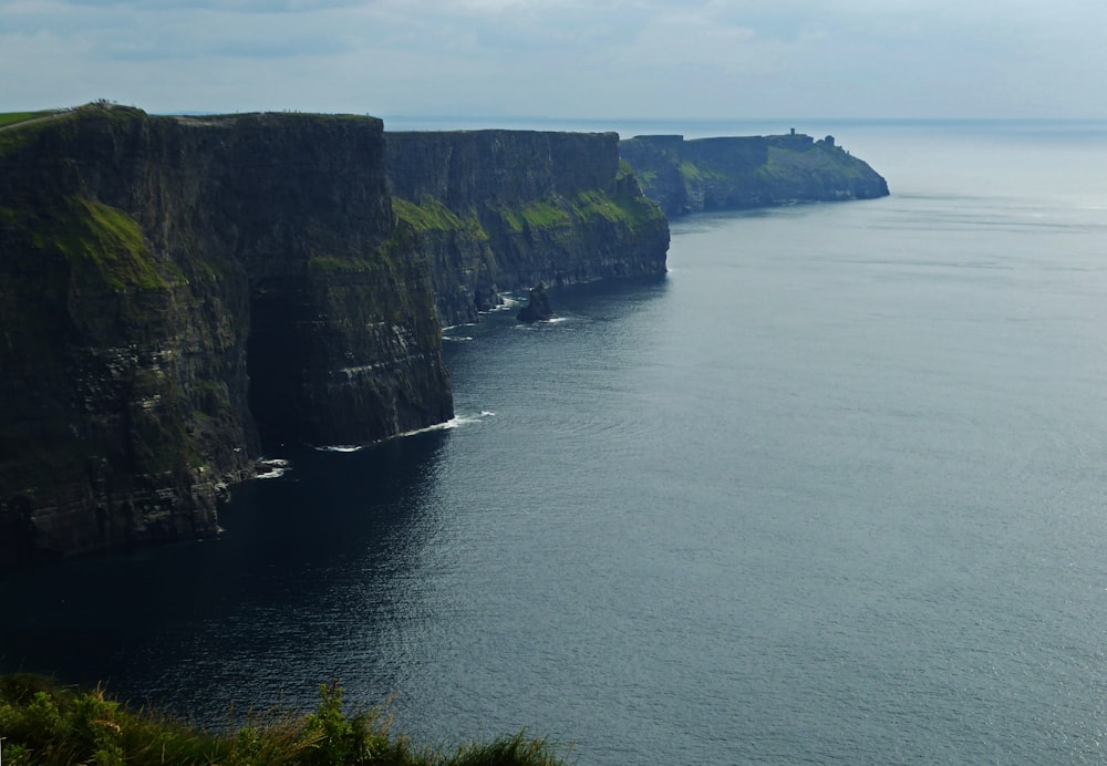 a large body of water near a cliff