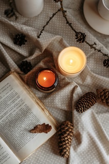 A digital tablet displaying one of the downloadable books offered by Chudneys Candle & Things, set against a backdrop of candles and cozy decor.