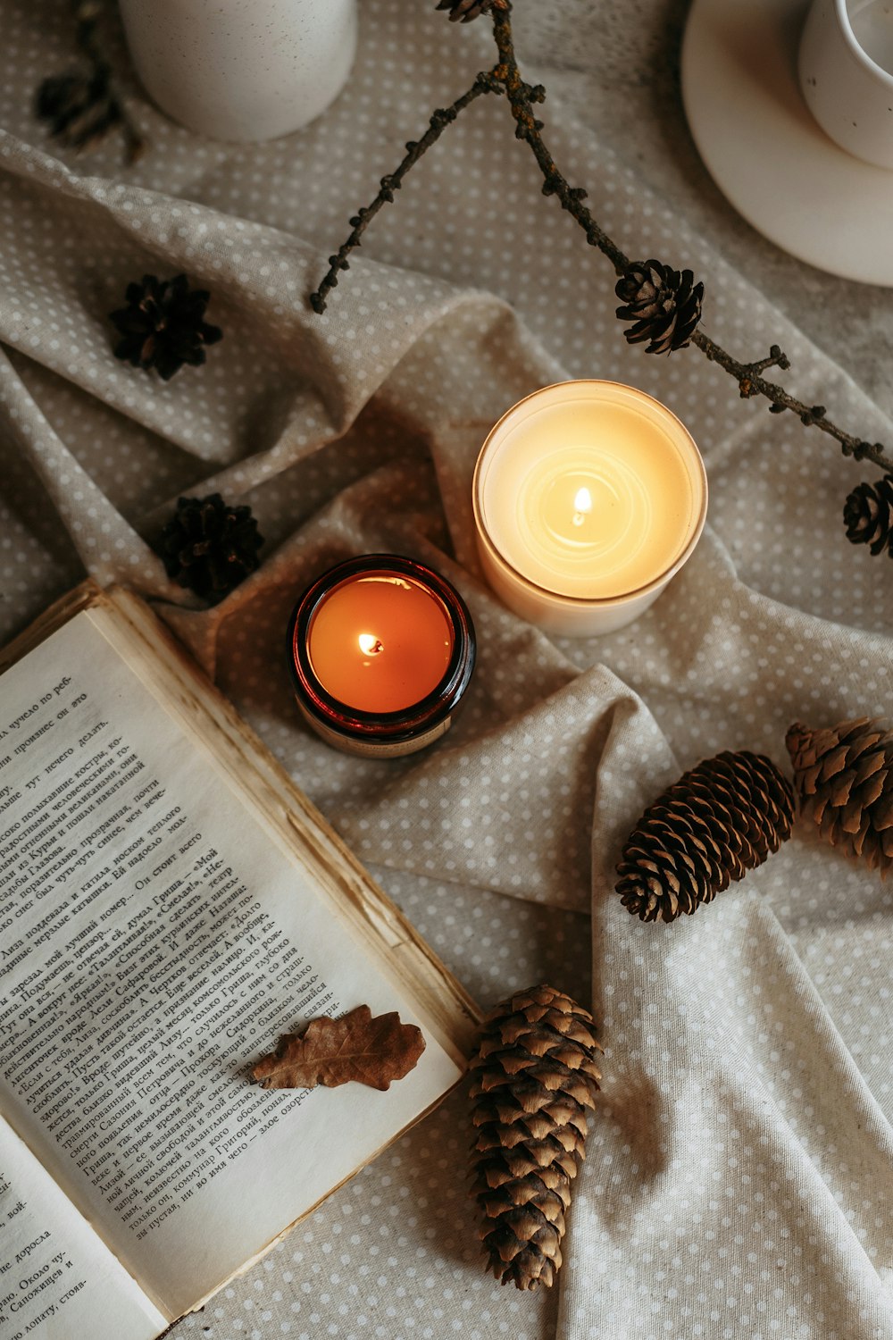 a book and a candle on a table