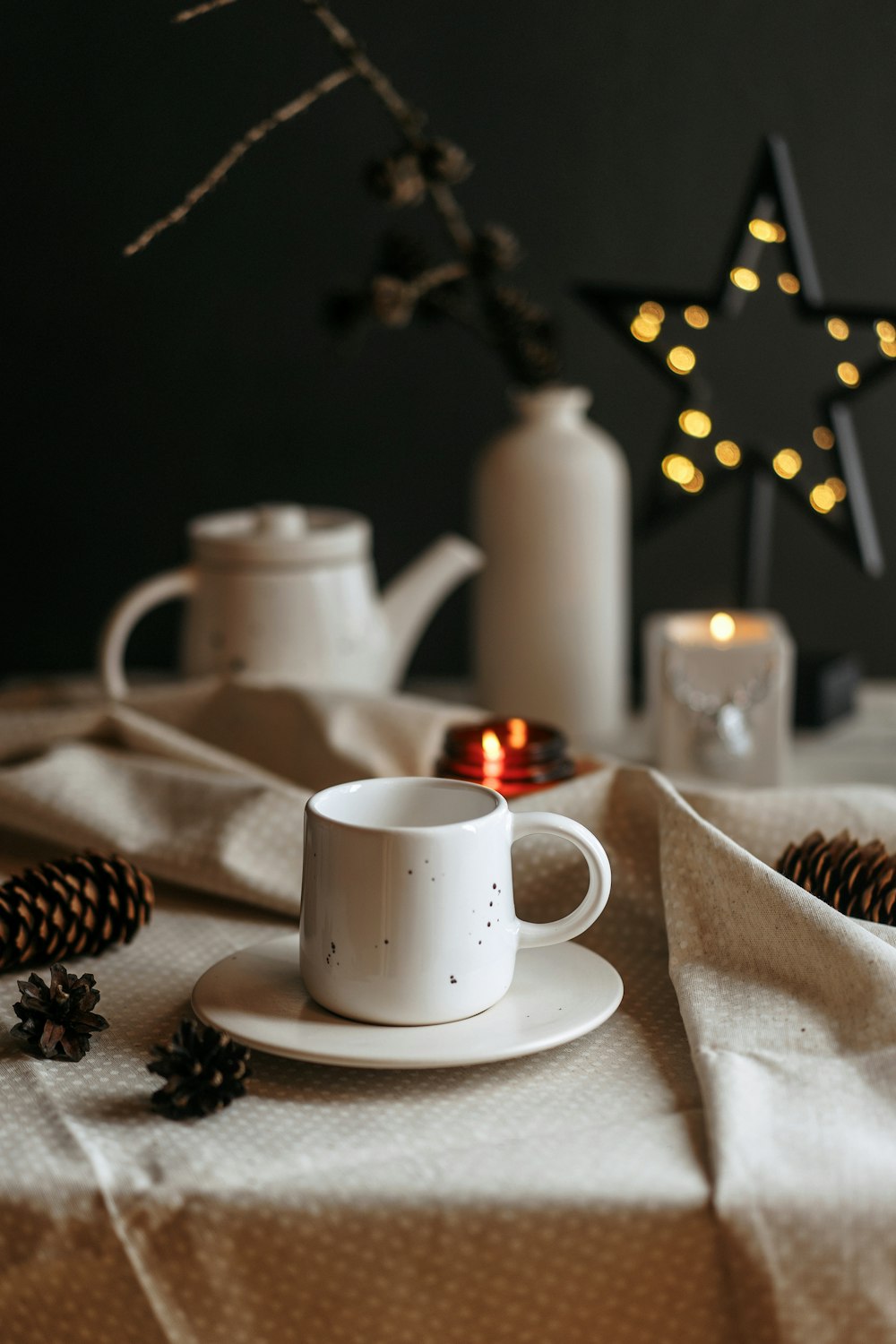 a white coffee cup sitting on top of a white plate