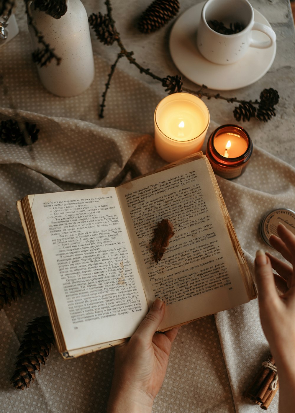 a person is reading a book on a table