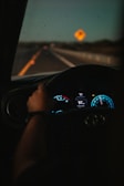 a person driving a car on a highway at night