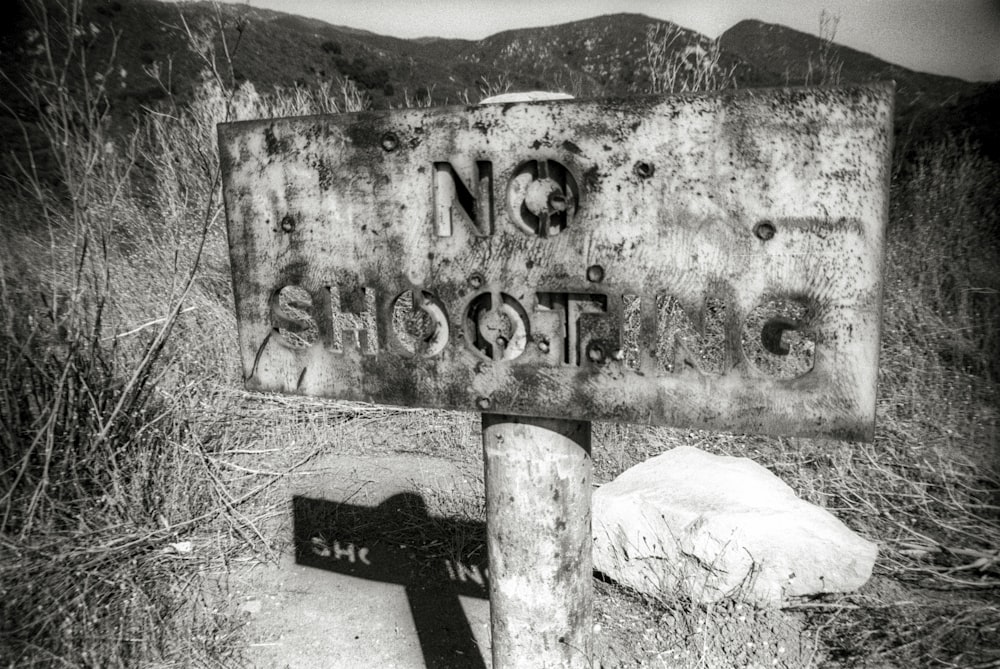 a black and white photo of a no parking sign