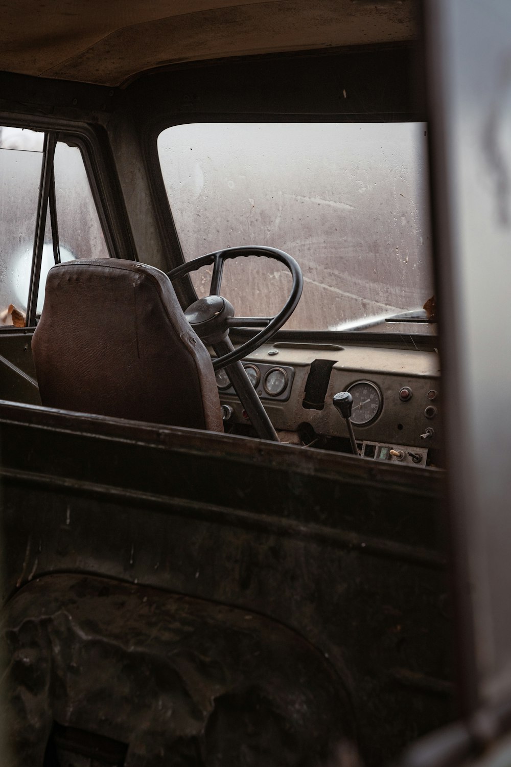 the interior of an old truck with a steering wheel
