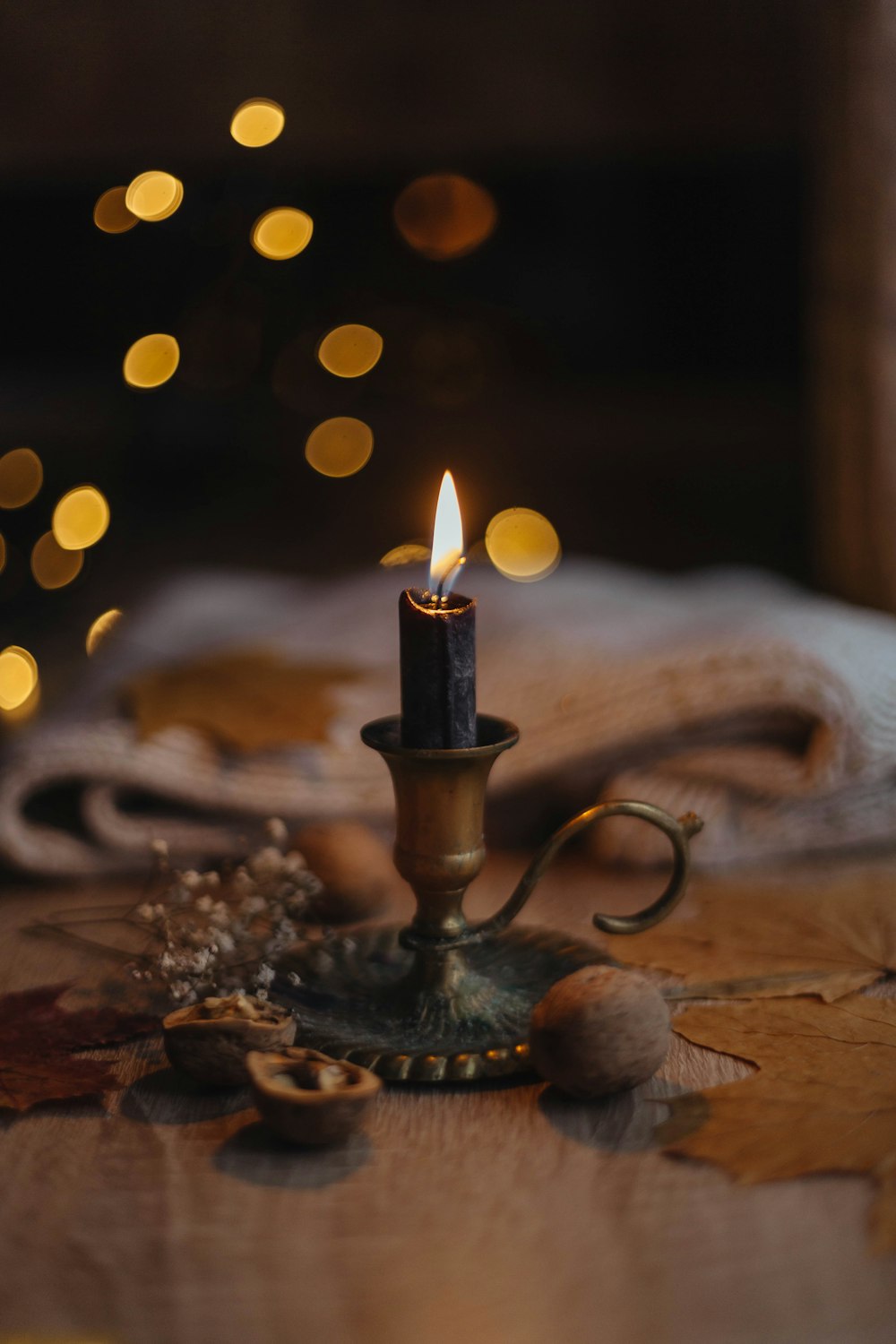 a lit candle sitting on top of a wooden table