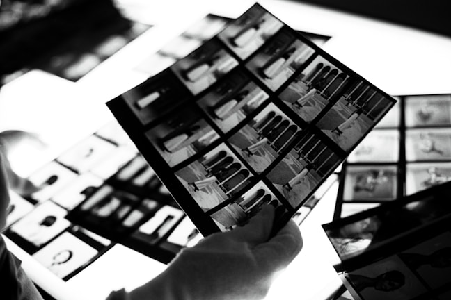Close-up of old film negatives being carefully handled for digitization.