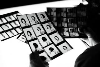 a person holding a bunch of pictures of people
