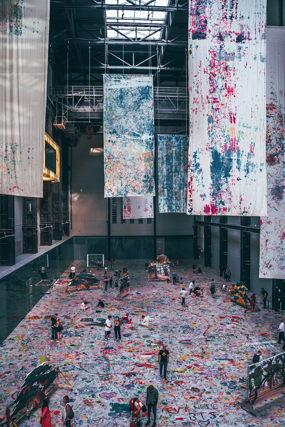 a group of people standing around a huge pile of trash