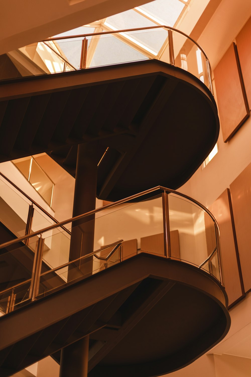 a spiral staircase in a building with a skylight