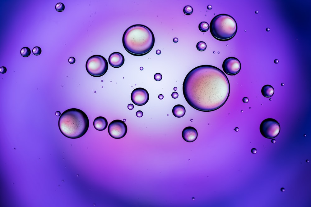 a close up of water bubbles on a purple and blue background