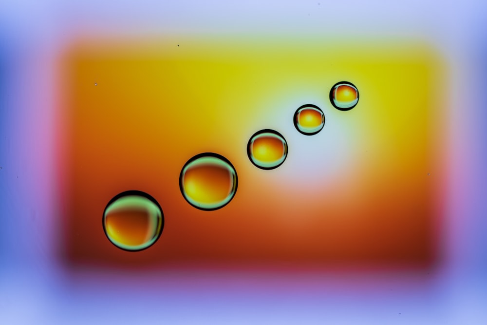 a group of bubbles floating on top of a blue and yellow background
