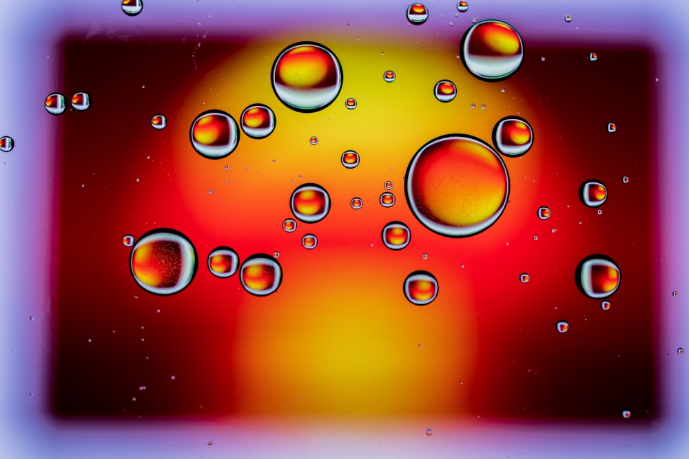 a picture of water bubbles on a red and yellow background