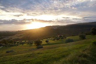 A scenic plot of land with a sunset in the background, highlighting natural beauty.