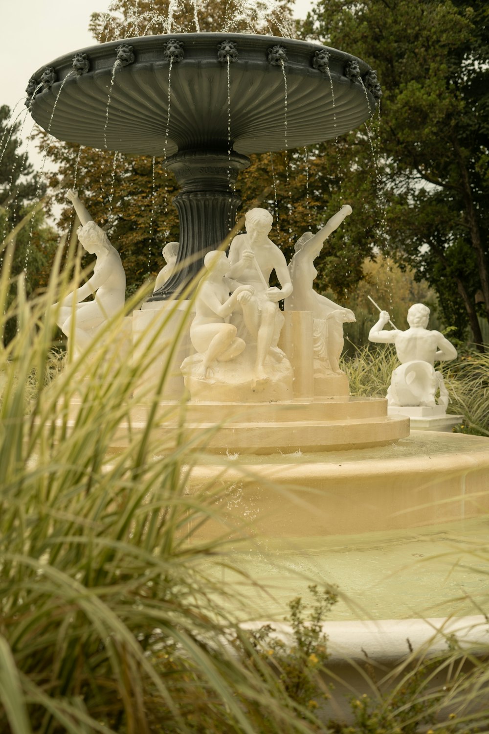 a fountain with statues of people in it