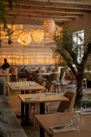 a restaurant with a tree in the middle of the room