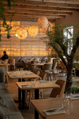 a restaurant with a tree in the middle of the room