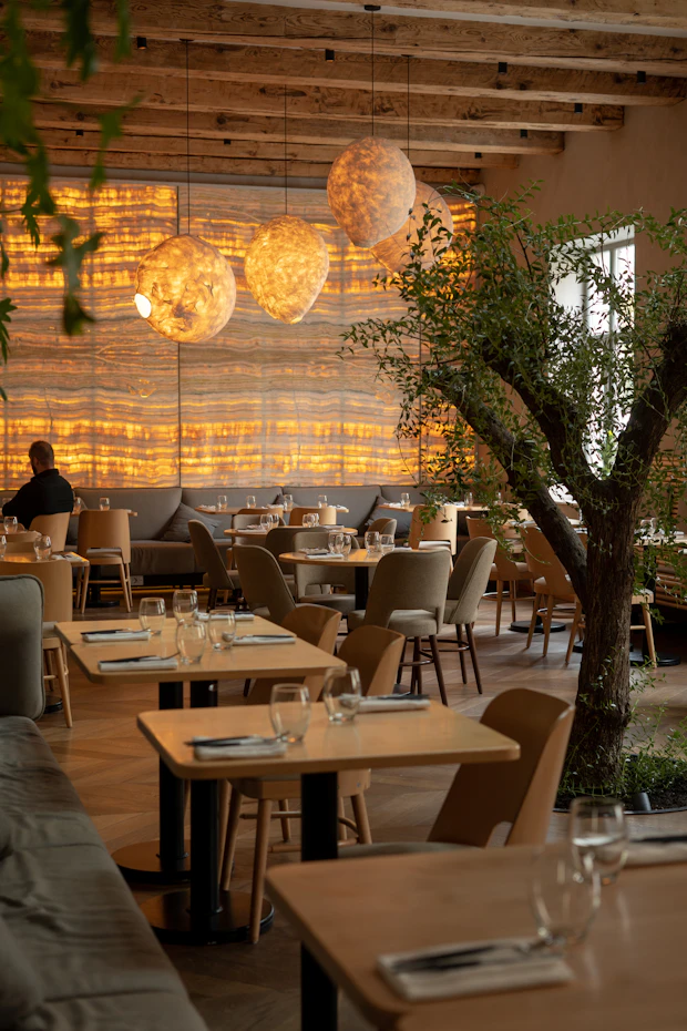 Bright restaurant with rattan pendants and timber seating
