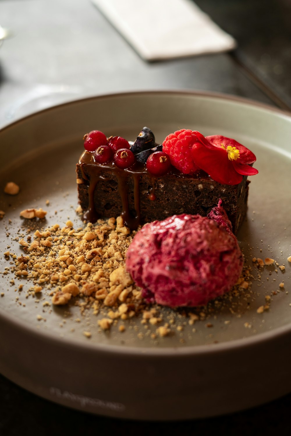 a plate topped with a piece of cake and a scoop of ice cream