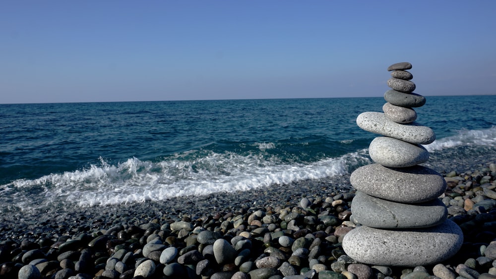 a stack of rocks sitting on top of a rocky beach