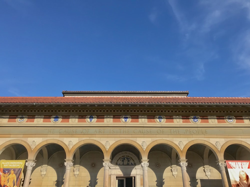 a building with arches and a clock on the front of it