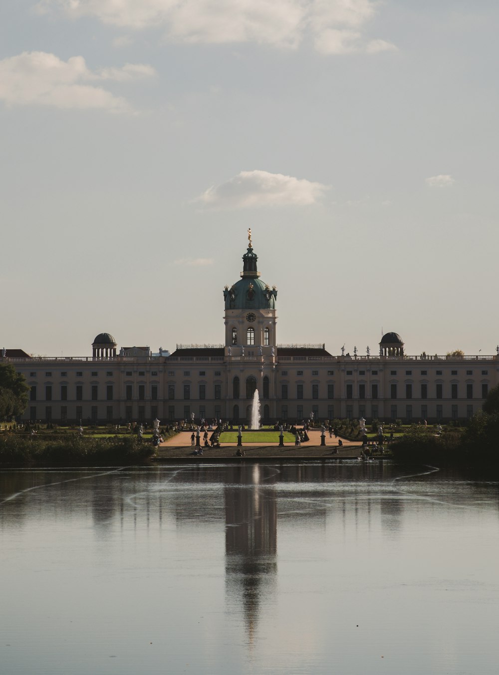 a large building with a fountain in front of it