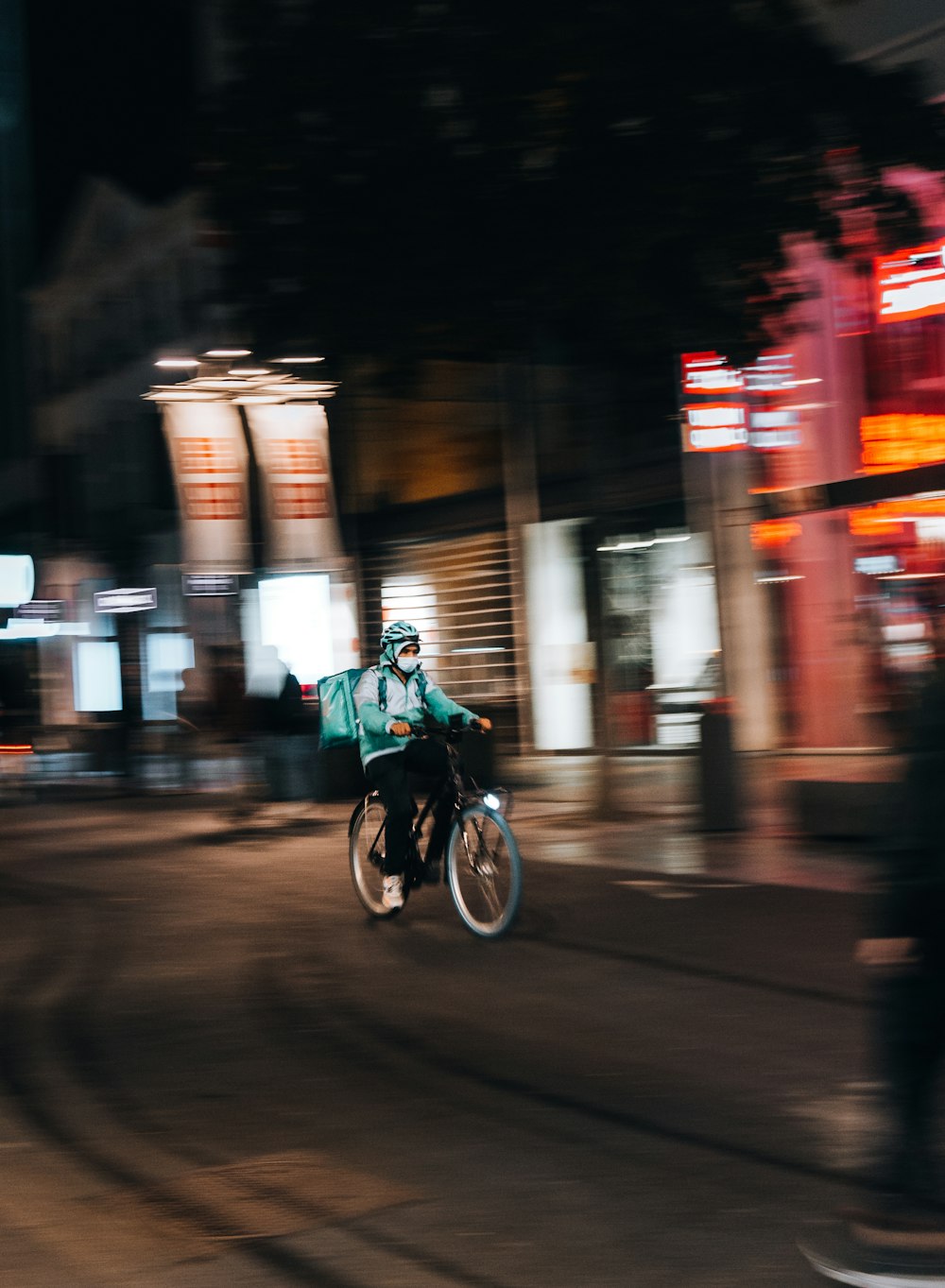 a man riding a motorcycle down a street at night